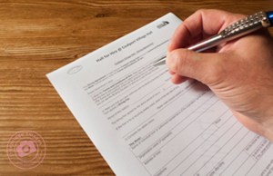 Photograph of a person signing a legal document, by Ironbridge Images